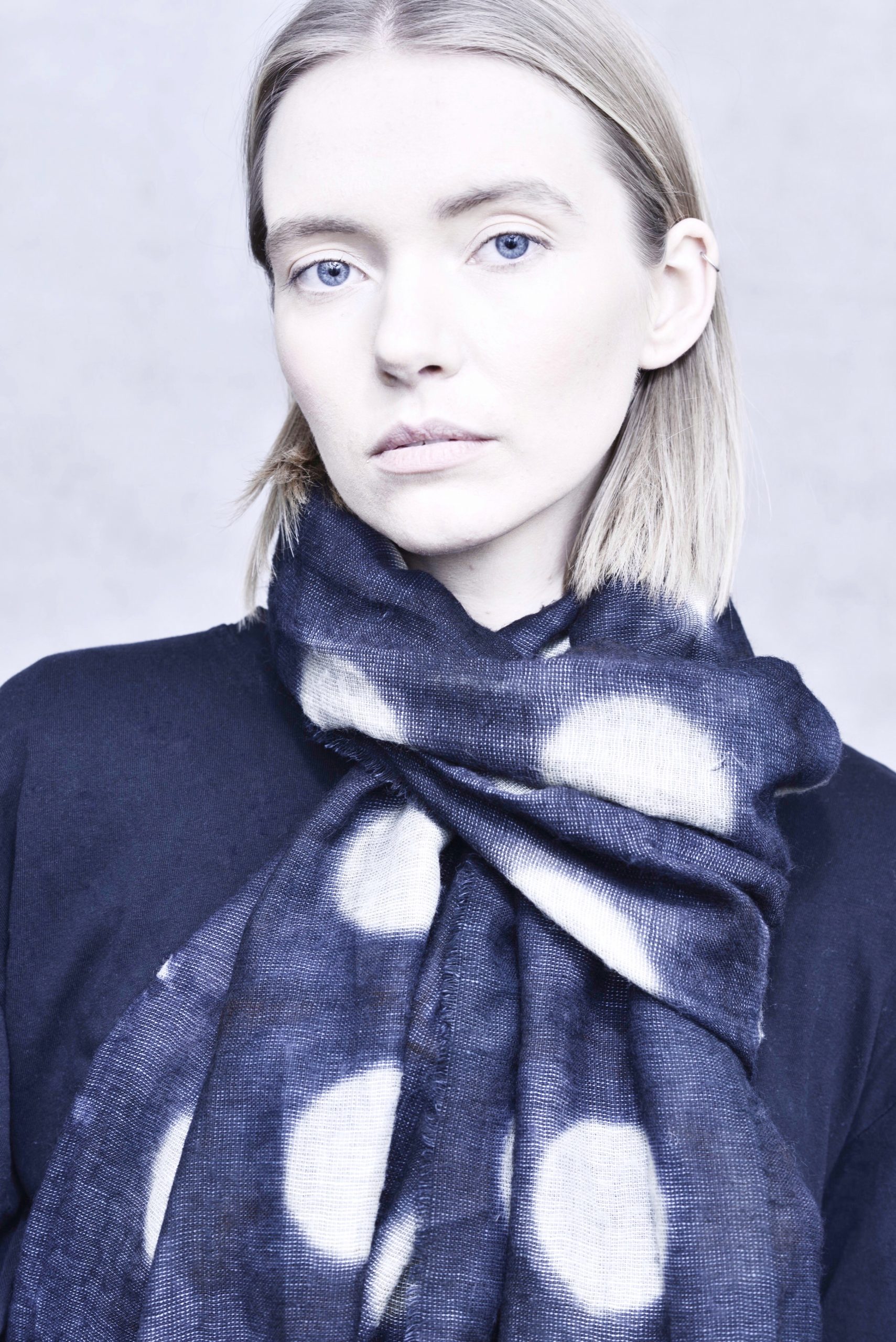 women model with dark blue scarf